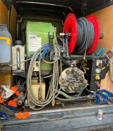 Jetting machine and hose reel in the back of the van
